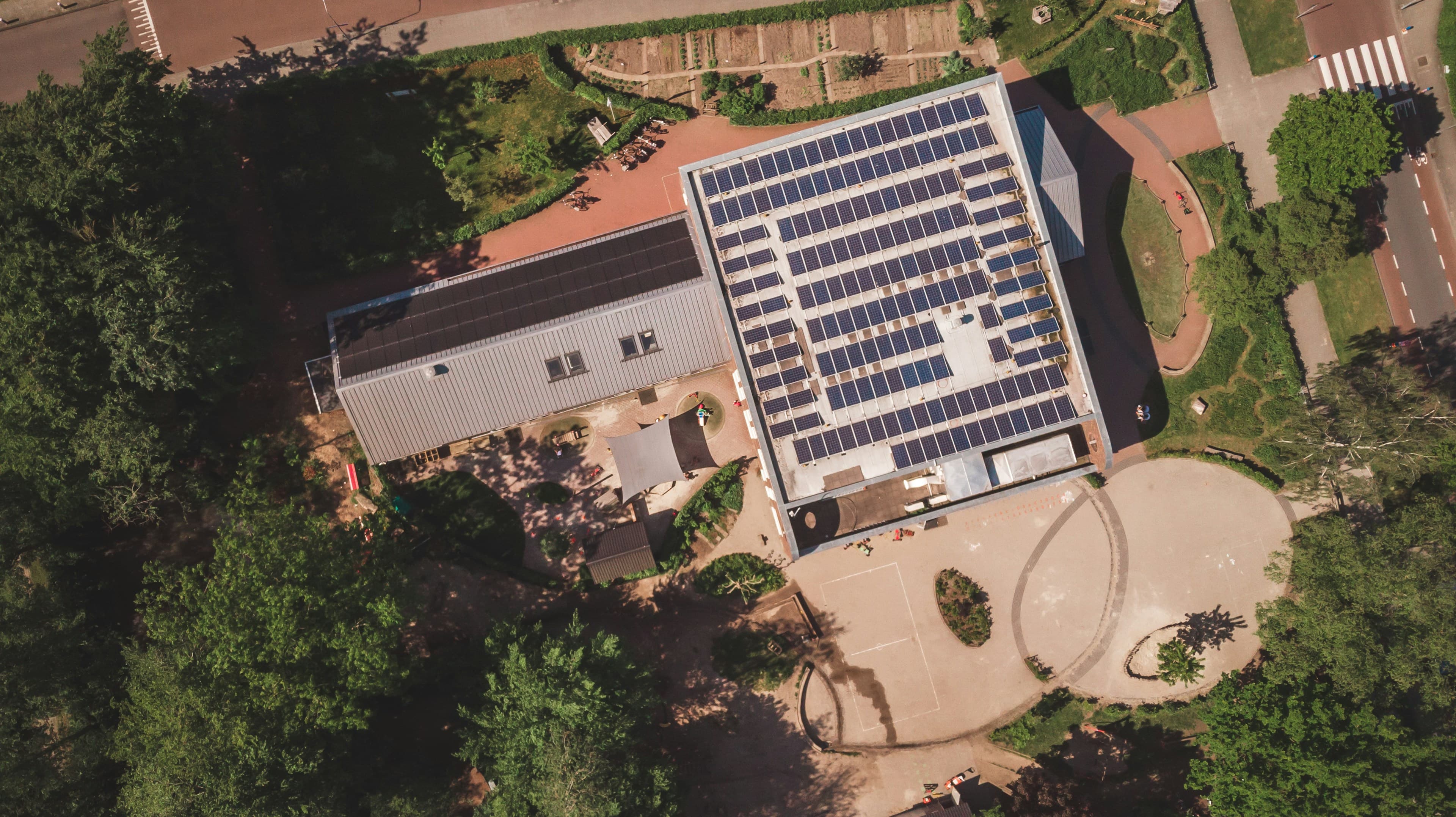 Aerial view of a residential rooftop solar array on Long Island — the kind of clean, low-penetration install a standing-seam metal roof makes possible